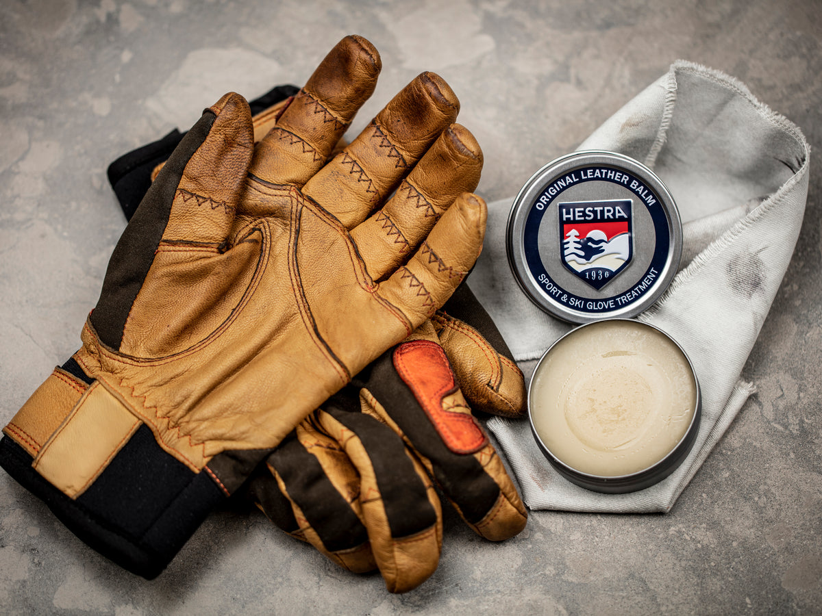 A pair of well-used Hestra leather gloves with natural patina