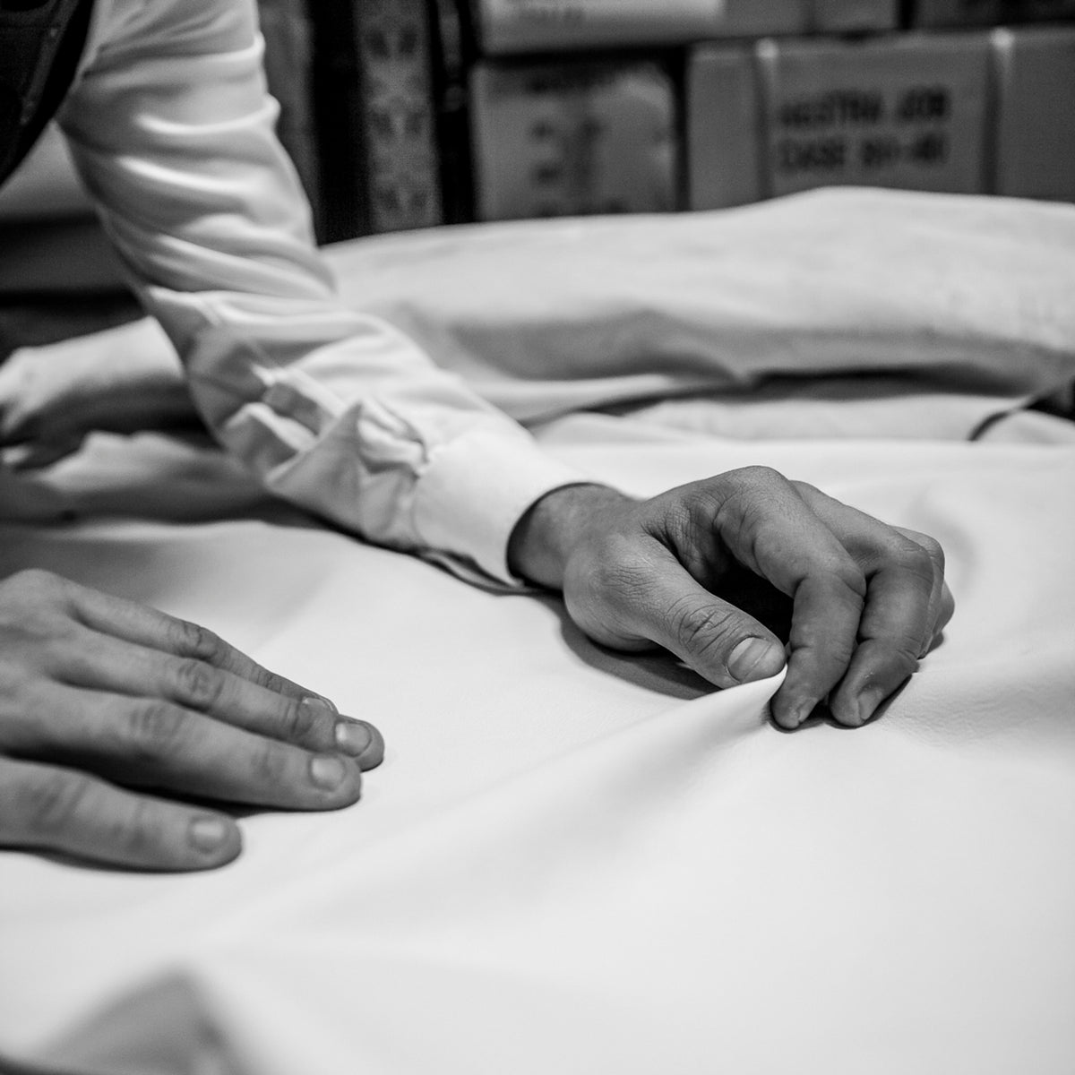 Inside our glove factory, with rows of workbenches and daylight through the windows