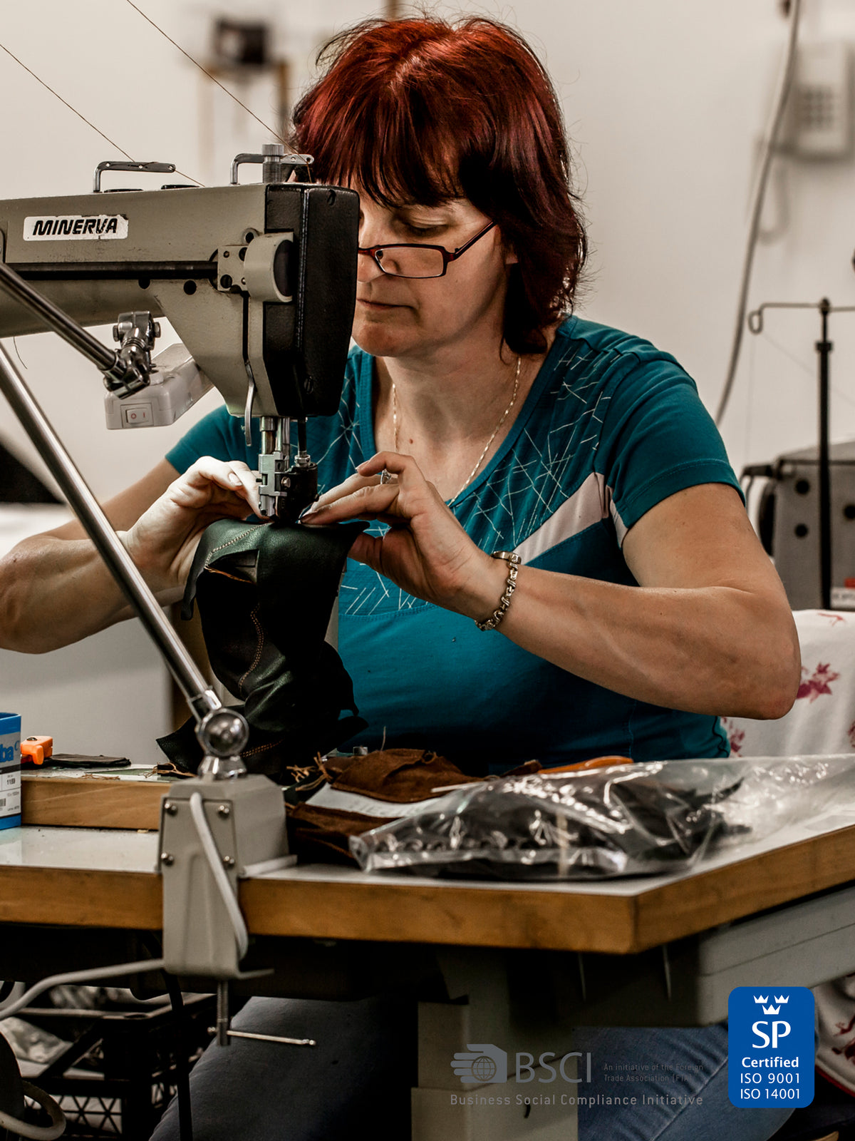 Close-up: one of our craftsmen's hands stitching a leather glove on an industrial sewing machine